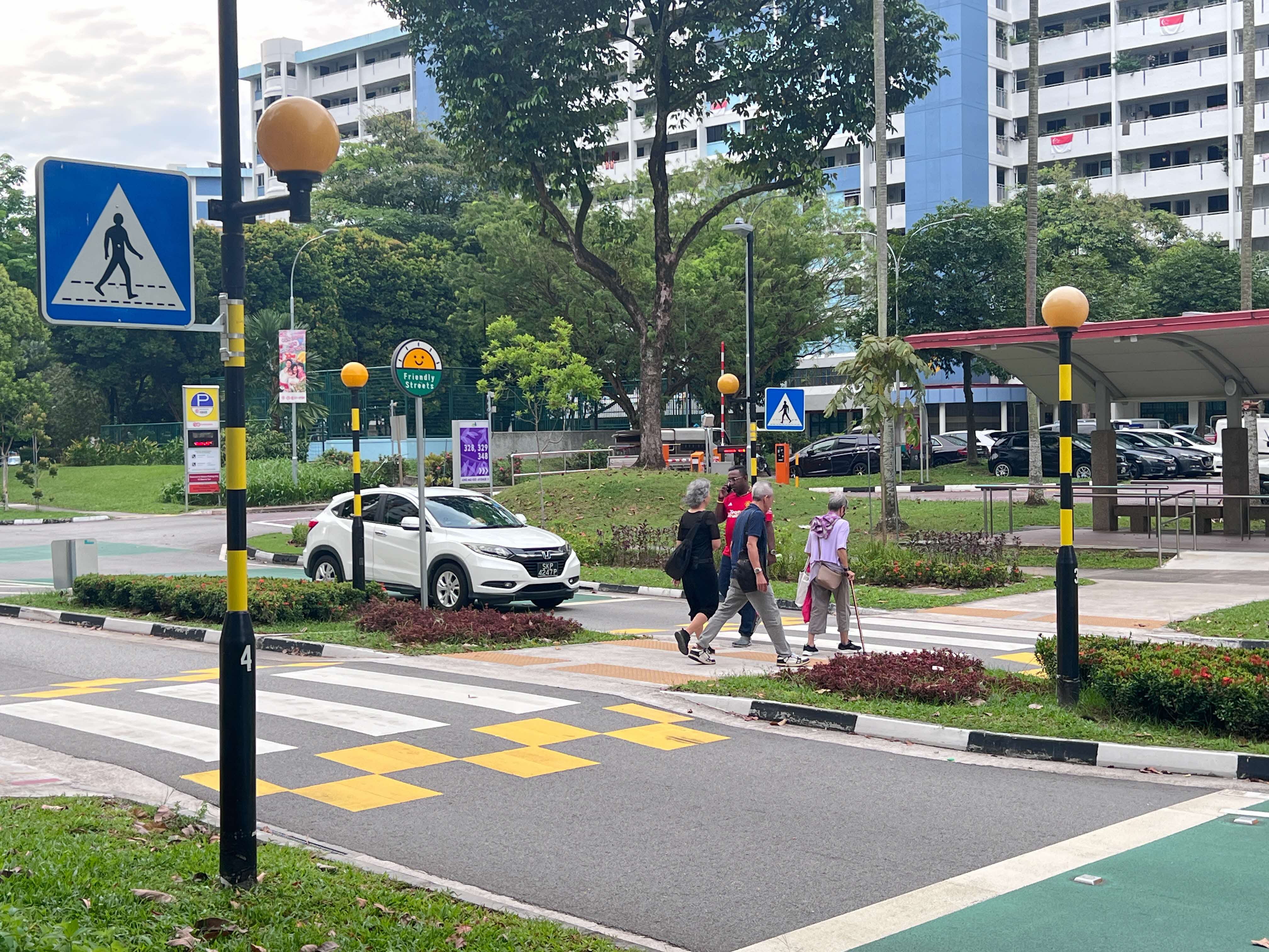 Residents crossing the road in Singapore